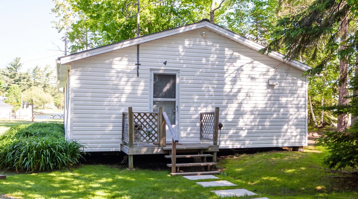 Pinegrove, a white three-bedroom cottage, seen from the lawn