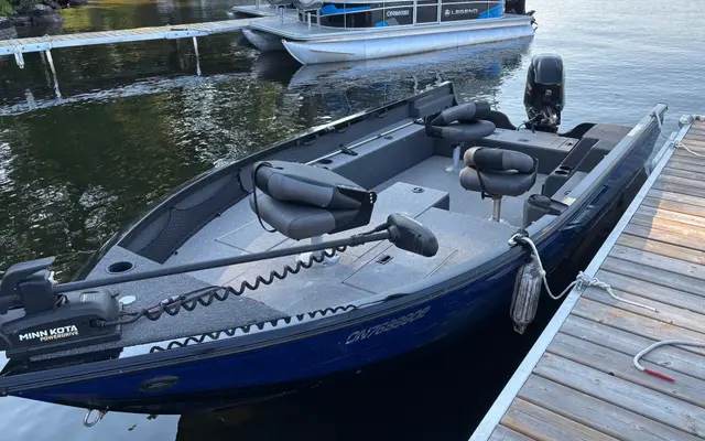 The Crestliner tiller boat at the dock