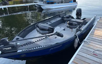 The Crestliner tiller boat at the dock