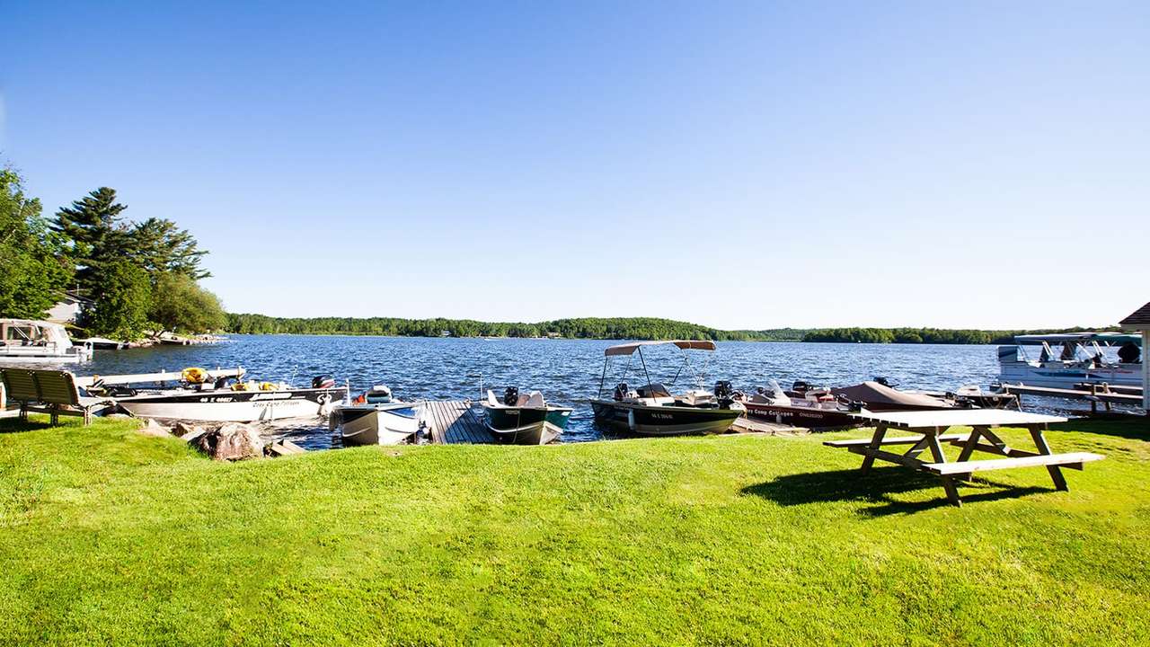 The lawn, picnic tables and boat docks along the Cozy Camp shoreline