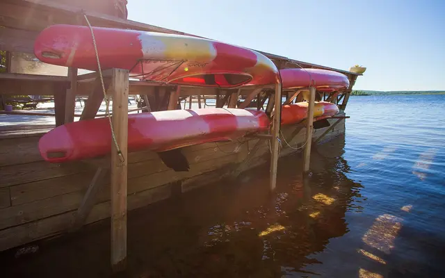 Red kayaks on the rack at the end of the dock