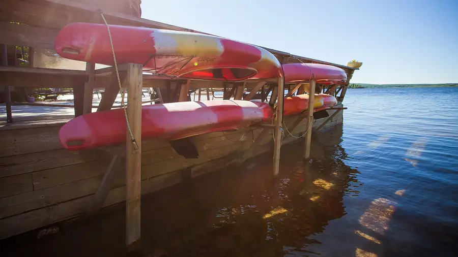 Red kayaks on the rack at the end of the dock