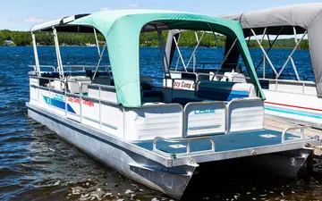 The 24 ft hard-top pontoon at the shore
