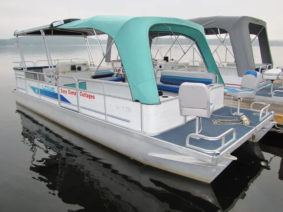 The Cozy Camp hard-top pontoon reflected in calm water