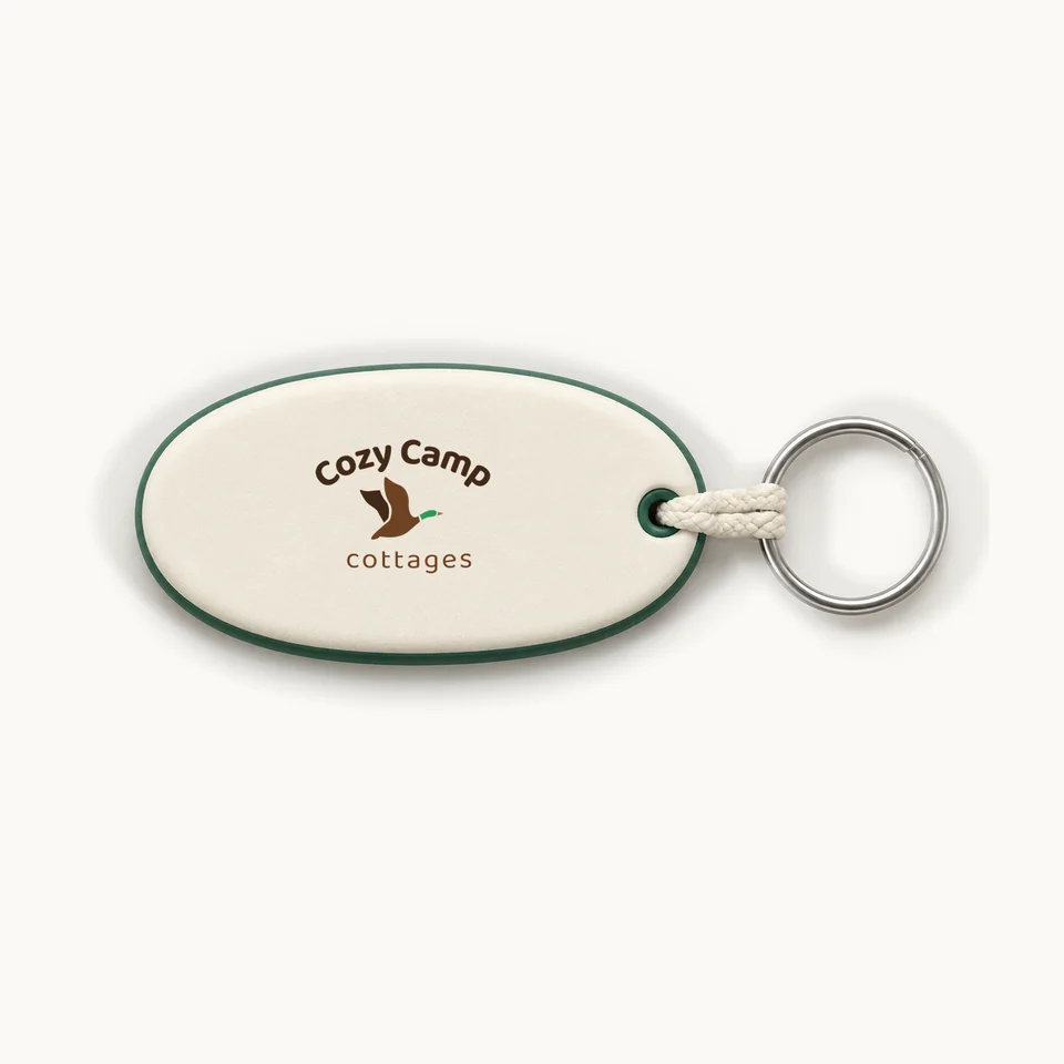 Cozy Camp Floating Keychain in Ivory & Pine, logo face and metal key ring, product concept